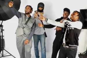 Music group, Aggy, about to have a photo shoot having a fun time 4 people in casual wear.