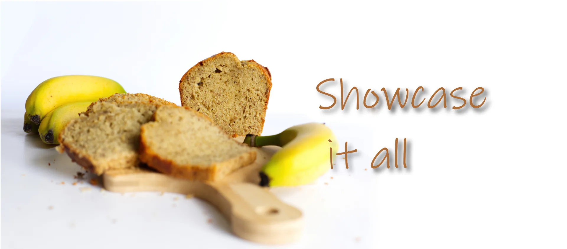Classic commercial photography of a banana bread sliced with an actual banana on a chopping board
