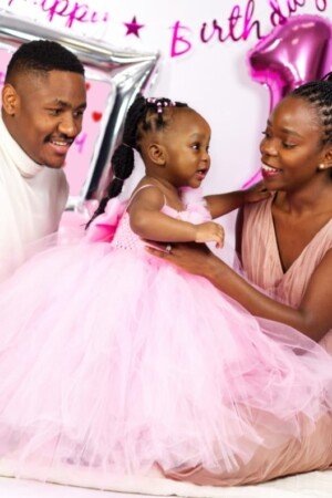 a man and woman holding a baby