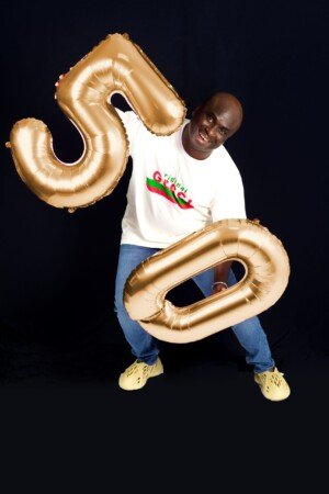 a man holding a gold balloon