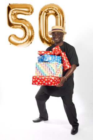 a man holding a pile of presents