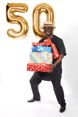 a man holding a pile of presents