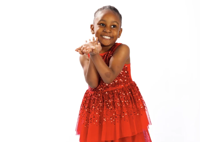 Young afro caribbean girl dress in red smiling